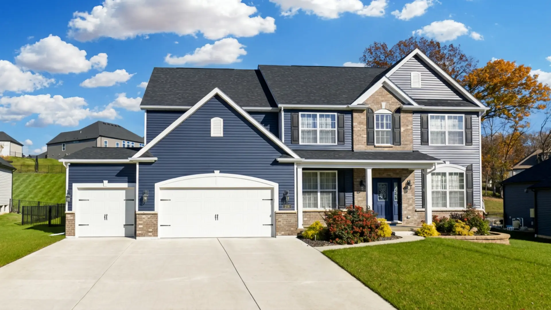 216 Everett Creek Court, O'Fallon, MO, navy two-story home with brick and three-car garage.