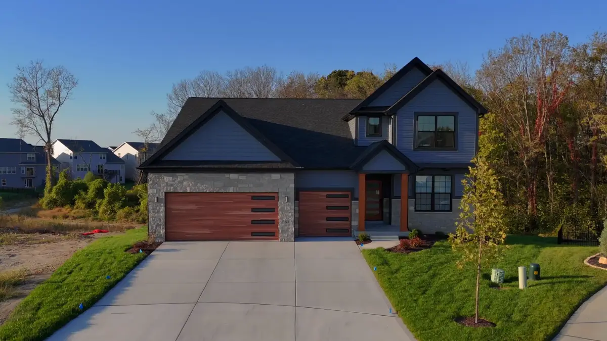 New Madison II by McKelvey at Cottleville Trails, two-story siding home with stone-and-wood accents.
