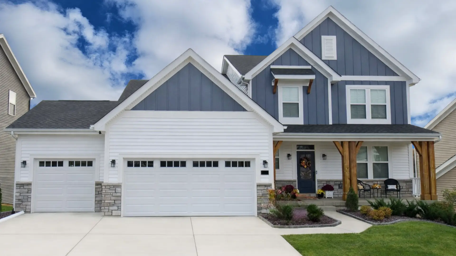 Streets of Caledonia home by Fischer Homes, white-and-grey two-story with double garage.